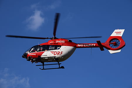 flight of white and red DRZ helicopter at daytime thumbnail