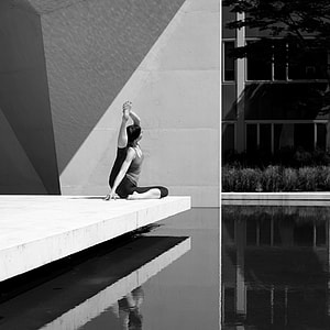 grayscale photograph of woman doing yoga thumbnail