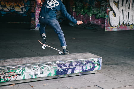 man skating on gray and white skate ramps thumbnail
