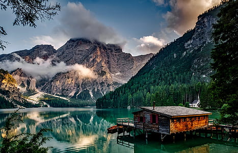 brown wooden house in front of mountain thumbnail