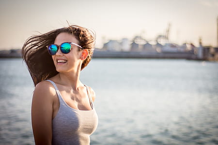 shallow focus photography of woman wearing gray spaghetti strap top thumbnail