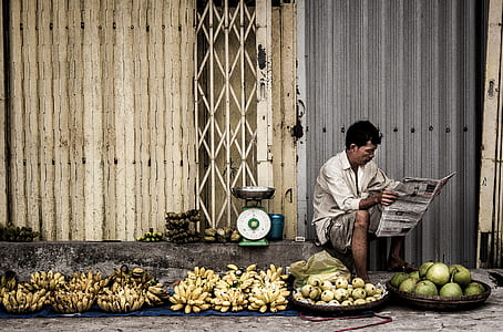 Man Sitting Near Fruits thumbnail
