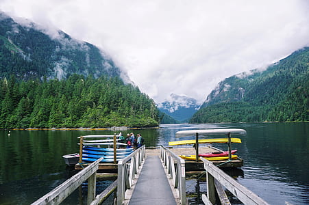 people riding on boat between mountain during daytime thumbnail