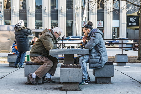 two men playing chess in the park thumbnail