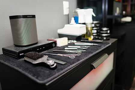 black handled brush beside square gray speaker thumbnail