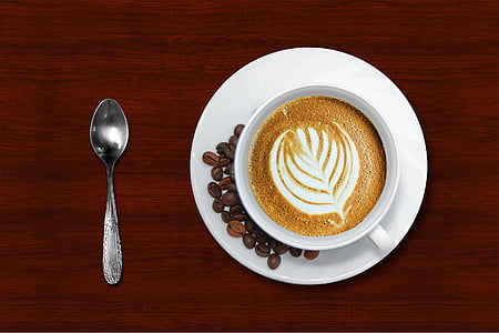 closeup photo of cup with saucer near spoon thumbnail