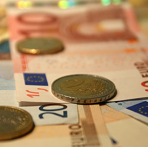 round gold-colored and silver-colored coin on banknote thumbnail