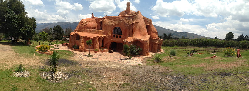 brown clay house near green trees under cloudy sky during day time thumbnail