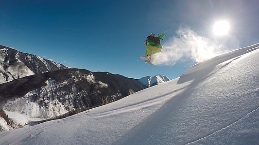 person playing snowboard during daytime thumbnail