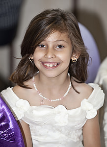 smiling girl wearing white sleeveless dress thumbnail