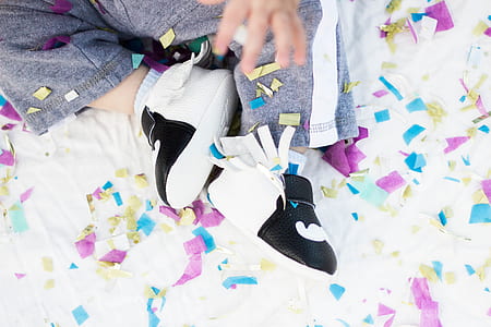 baby wearing pair of shoes with confetti thumbnail