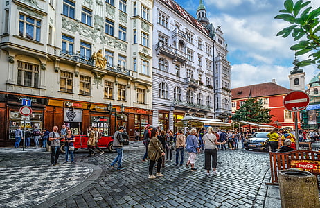 people walking on street between buildings during daytime thumbnail