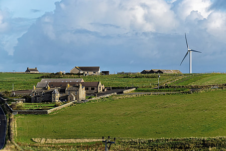 beige house on grass field near windmill thumbnail