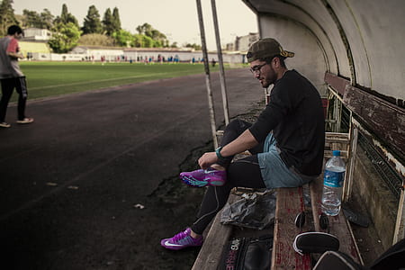 man sitting on brown bench thumbnail
