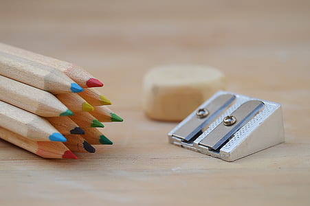 selective focus photography of pencil sharpener on brown surface thumbnail