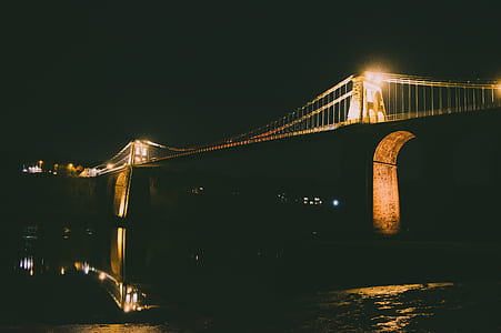 lighted concrete bridge at nighttime thumbnail