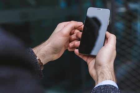 Man hands holding modern smartphone with blank black screen thumbnail
