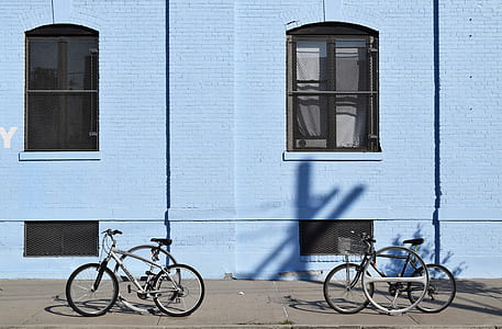 two black bikes outside building thumbnail
