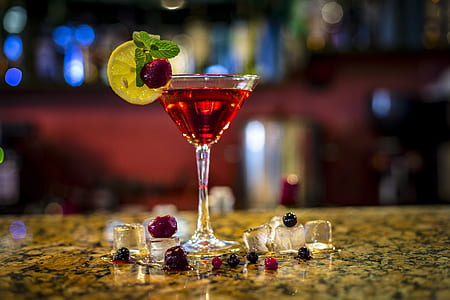 clear cocktail glass filled with red liquor thumbnail