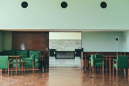 painting of rectangular black cabinet beside green padded sofa sets thumbnail
