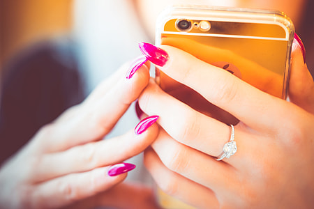 Young Woman Using Her Gold Smartphone thumbnail