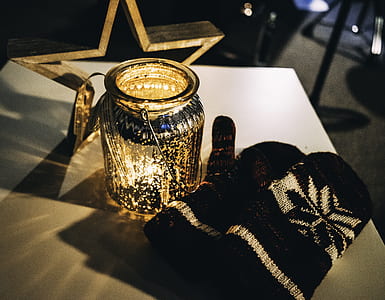 black-and-gray snow gloves beside jar thumbnail