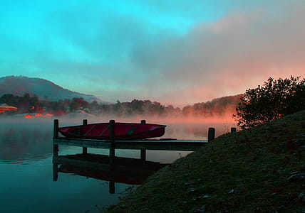 A canoe resting on a lakeside dock in the morning thumbnail