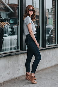 woman standing beside glass window thumbnail