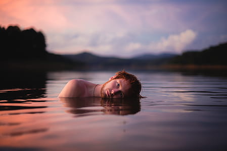 topless man on body of water thumbnail