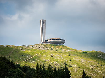 white and gray concrete building at the top of the mountain thumbnail