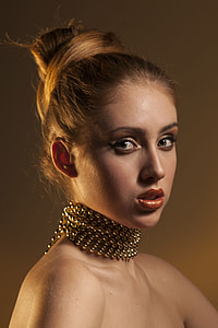 woman wearing beaded gold-colored necklace thumbnail