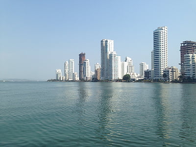 high-rise building lot beside calm body of water under clear sky during daytime thumbnail