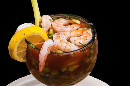 shrimp soup with spring onions filled clear drinking glass with sliced lemon on edge closeup photo thumbnail
