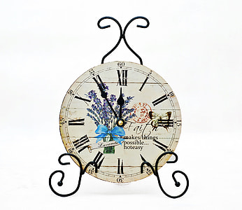 round white analog clock on black metal stand thumbnail