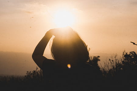 silhouette of woman holding her head during daytime thumbnail