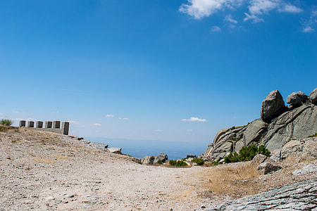 gray rock formations on valley under blue sky during daytime thumbnail