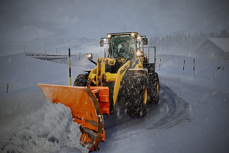 man riding backhoe plowing snow thumbnail