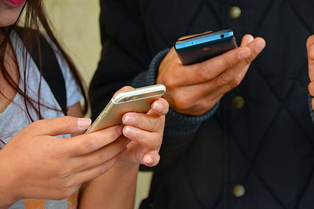 two person holding smartphones thumbnail