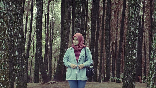 woman standing near trees during daytime thumbnail