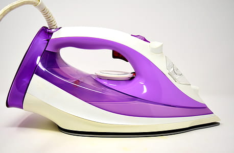 close-up photo of purple and white steam clothes iron thumbnail
