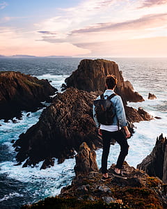 man standing on rock mountain thumbnail