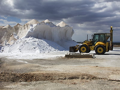 yellow loader near white rock at daytime thumbnail