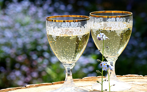photo of two clear footed glasses filled with liquid thumbnail