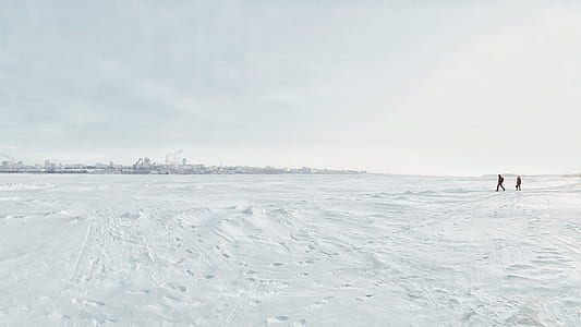 two people standing on snow ground thumbnail