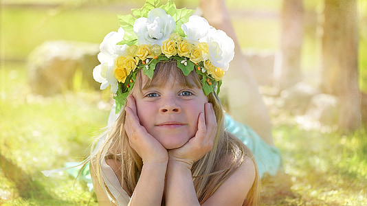 girl wearing flower crown lying on the grass thumbnail