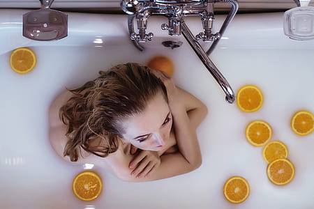 topless woman soaking in bathtub thumbnail