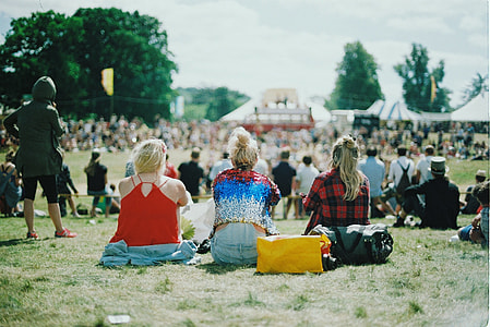 three woman sitting on green lawn on picnic ground during day time thumbnail