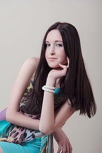 black long haired woman wearing pearl bracelet and mini dress thumbnail