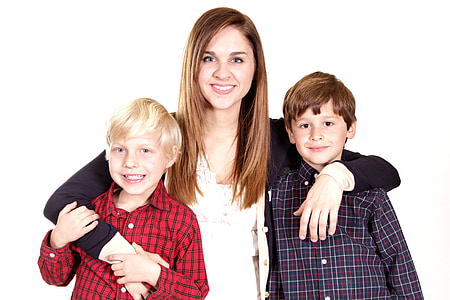 woman wearing white shirt and black cardigan holding two child thumbnail