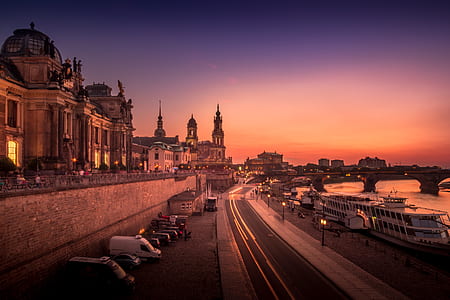 time-lapse photography of road near buildings and body of water with bridge thumbnail
